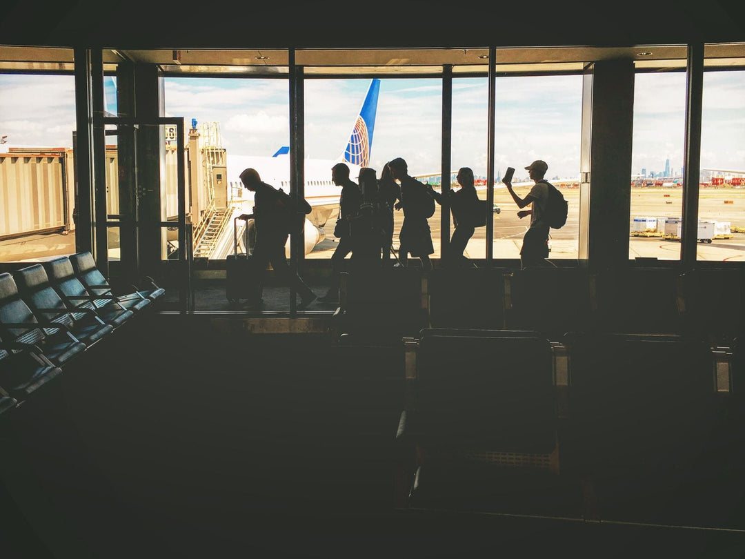 travelers walking through an airport terminal before a long flight