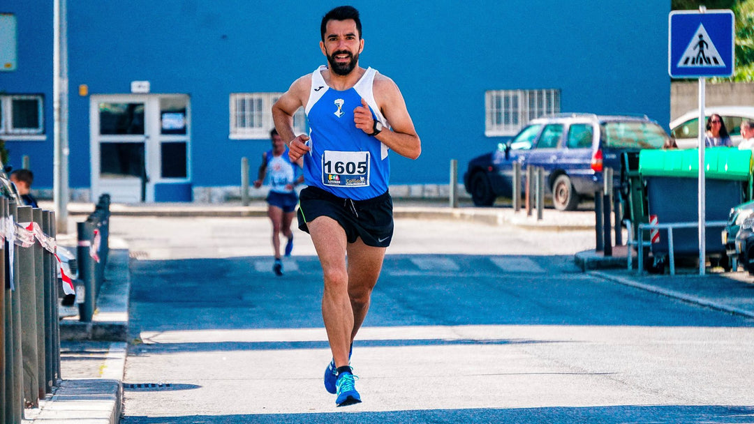 male marathon runner sprinting on an urban road during training