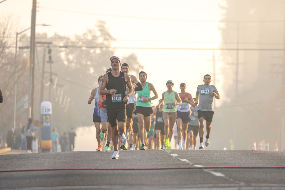 group of runners training on a foggy morning road