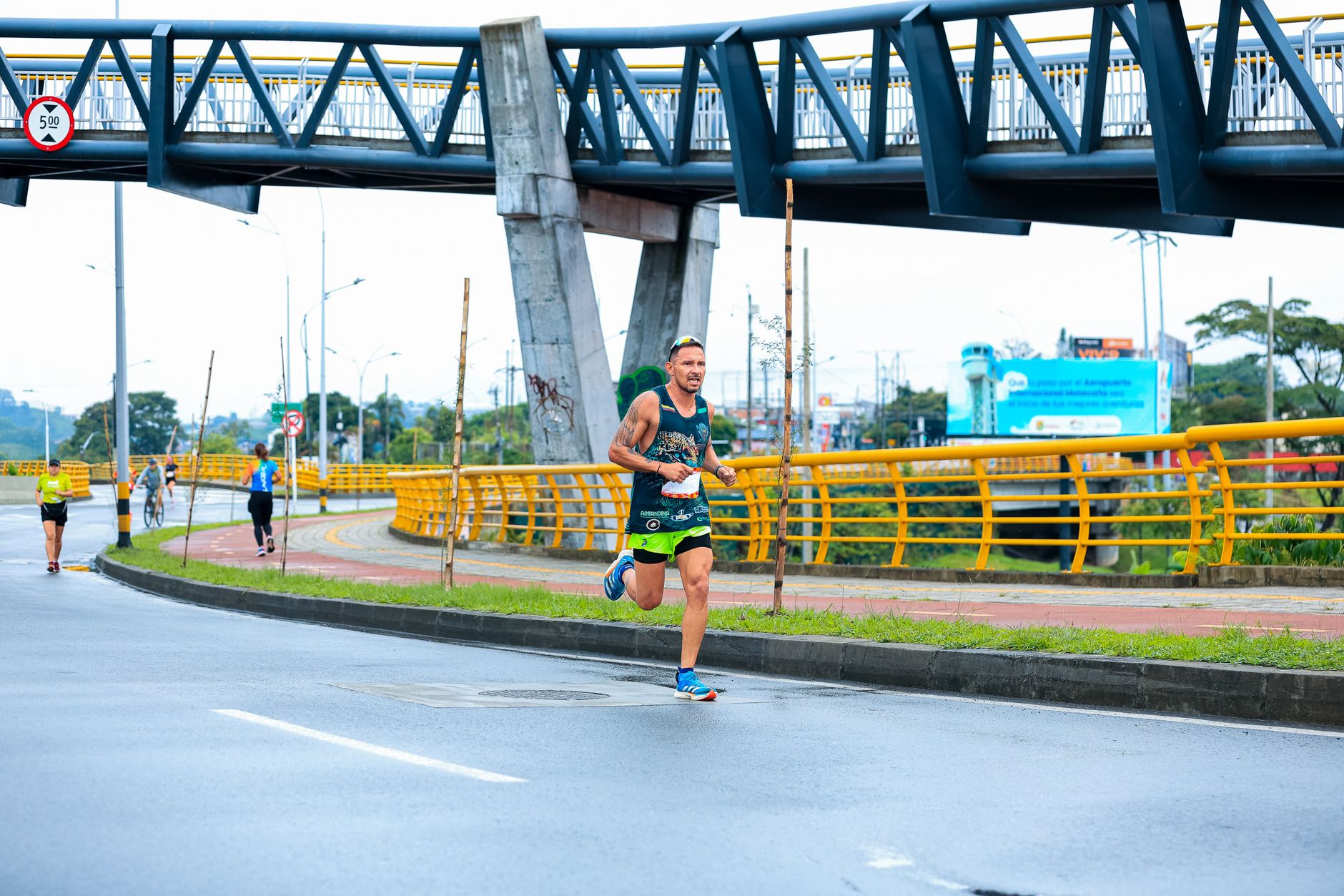 Man running in an urban marathon, showcasing athletic endurance and cityscape.