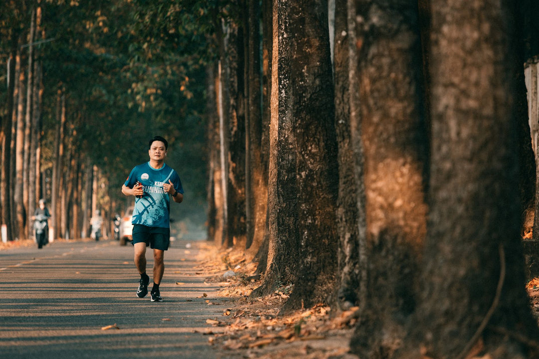 Runner jogging along a scenic tree-lined road
