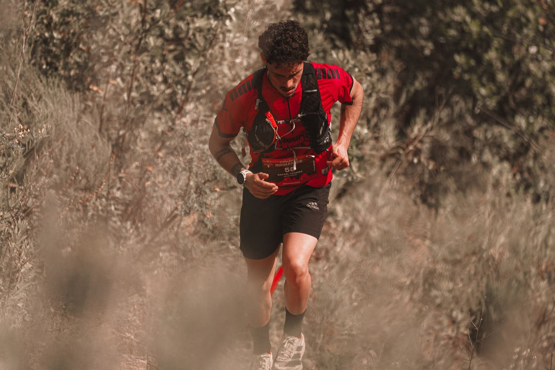 Athletic man trail running in a natural setting, showcasing endurance and determination