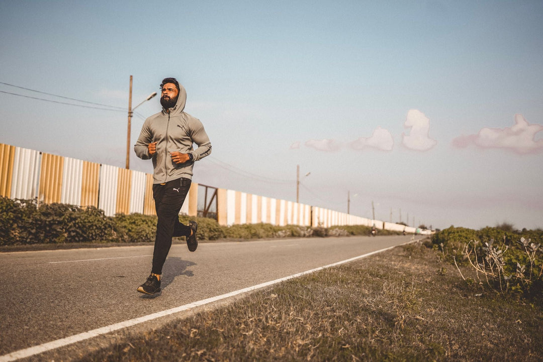 runner wearing low-profile socks on an open road during endurance training