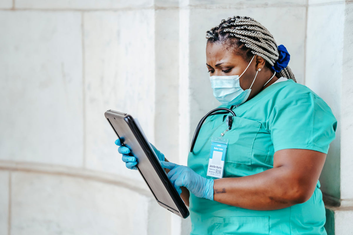 nurse in medical uniform walking through a hospital hallway during a long shift