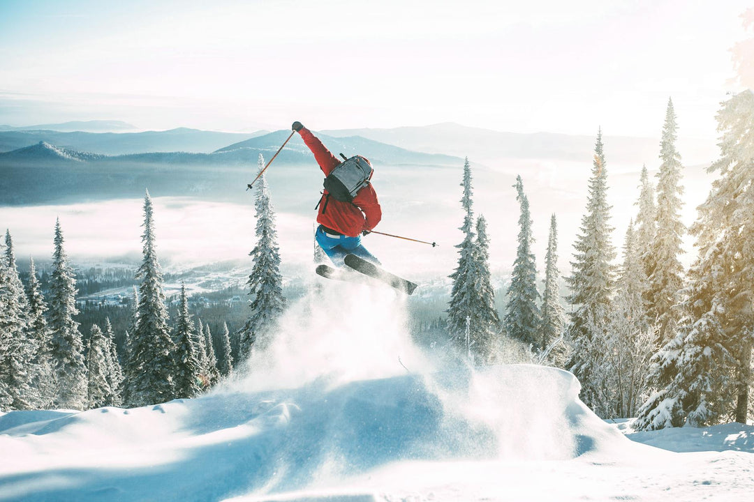 Skier performing a stunt in a snowy landscape, showcasing winter sports and adventure.