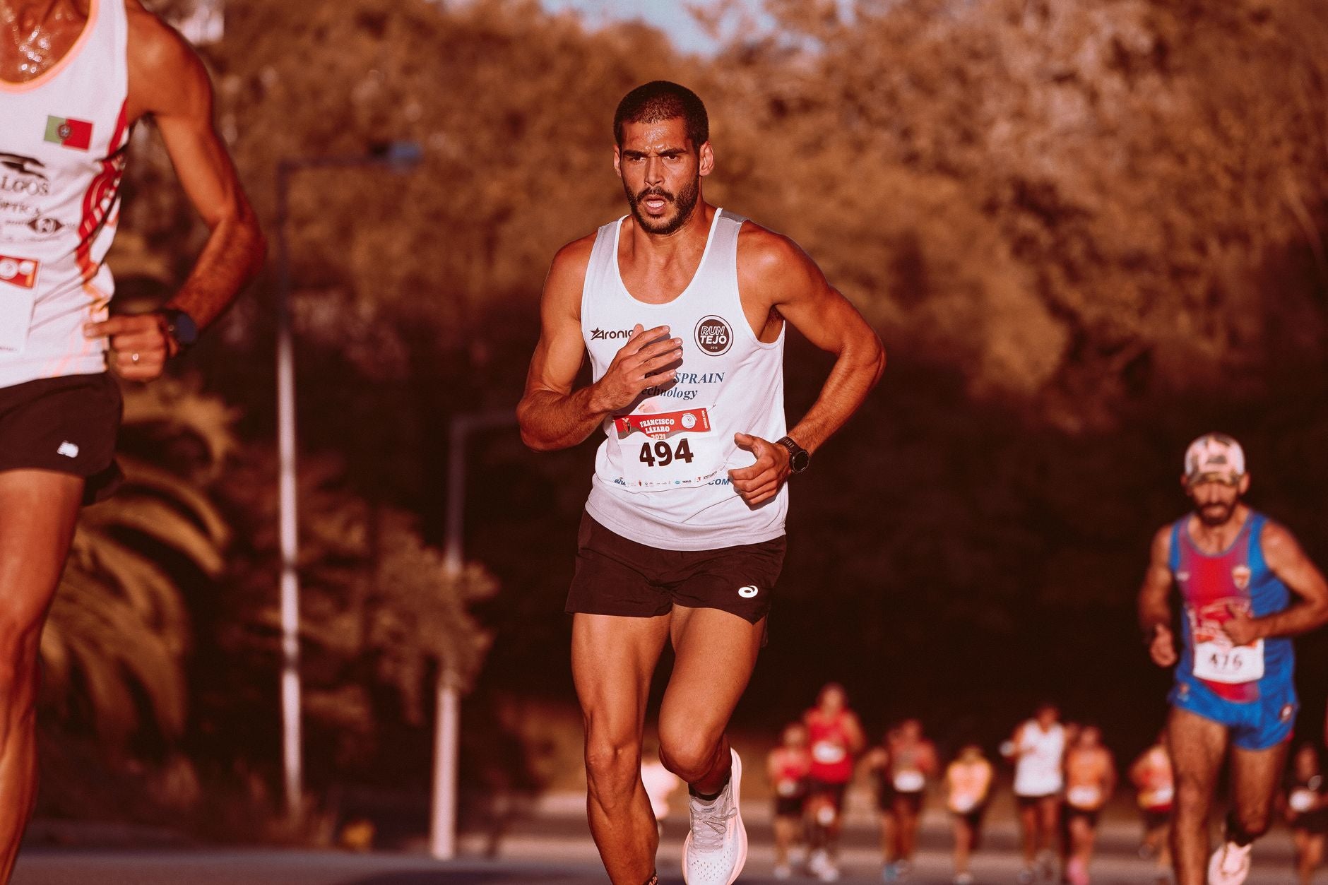 Marathon runners competing outdoors, showcasing determination and athleticism.